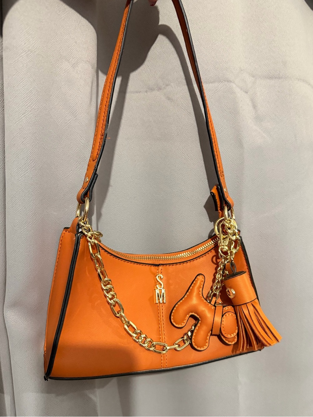 Orange Leather Shoulder Bag with Gold Chain and Tassel